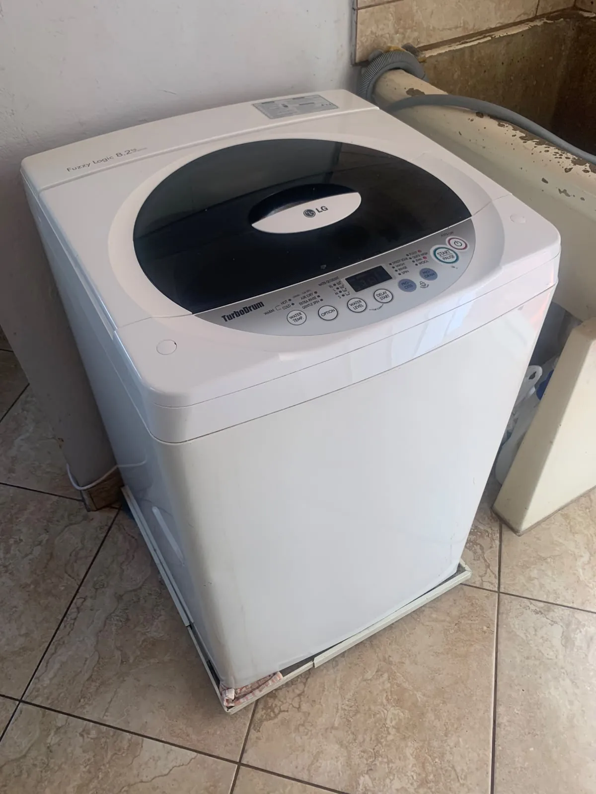 Top-loader washing machine being assessed in Durban